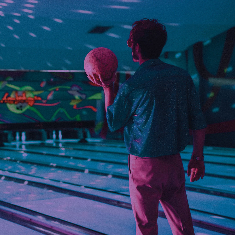 man bowling with disco lights